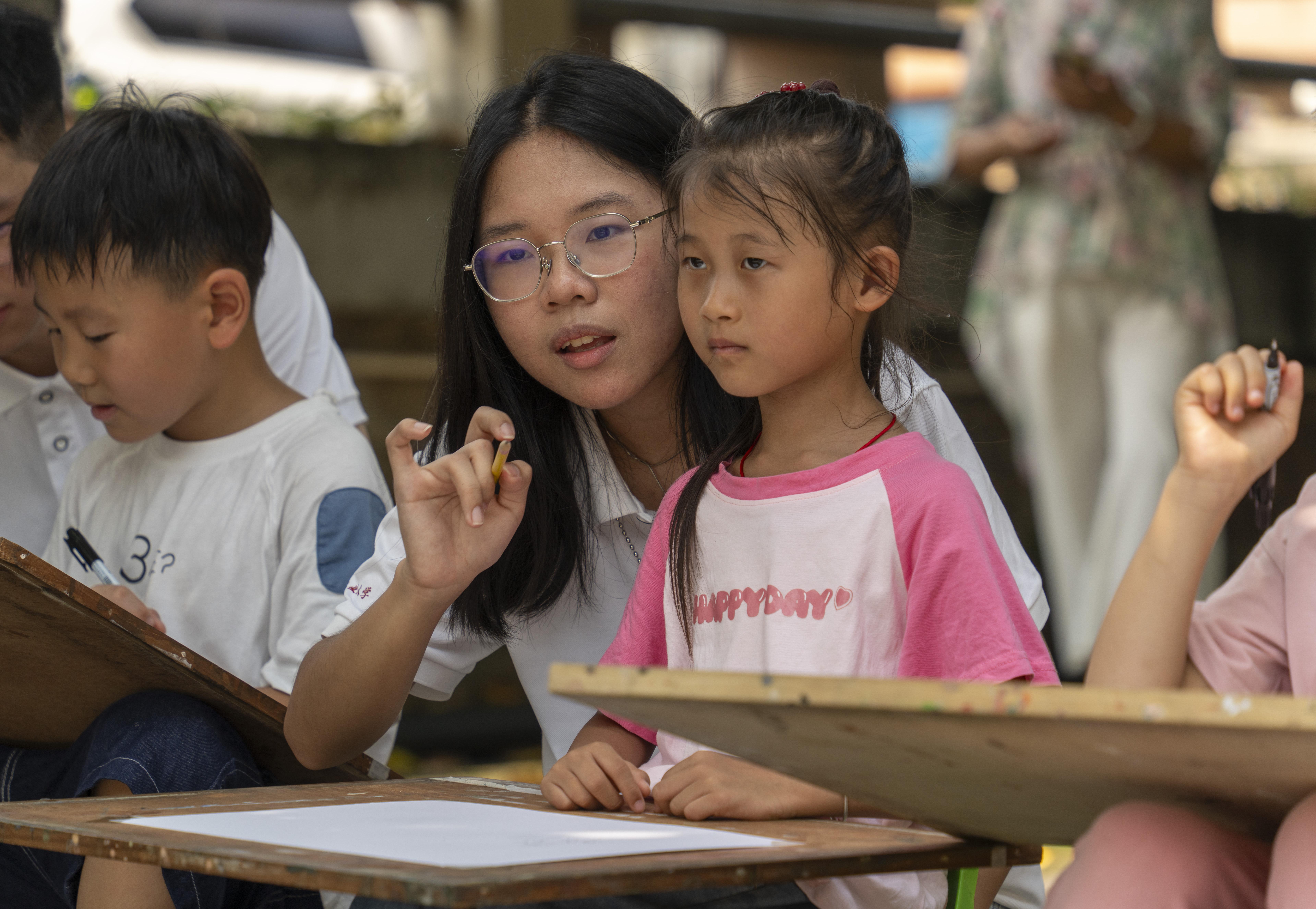 12.突击队成员对社区儿童进行绘画指导